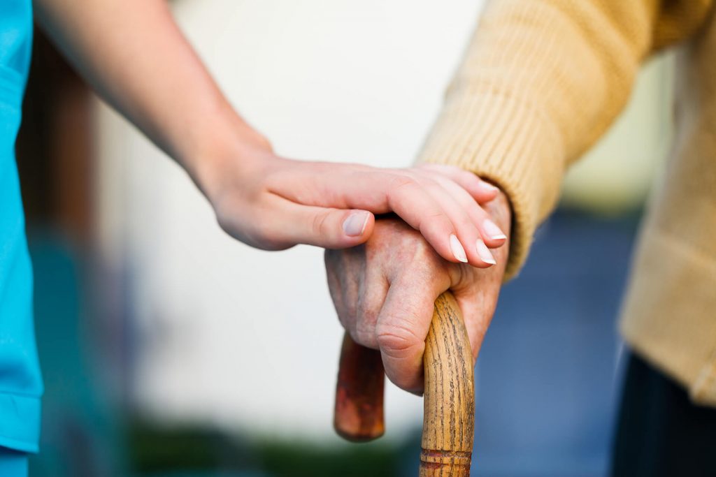 woman helping elderly man